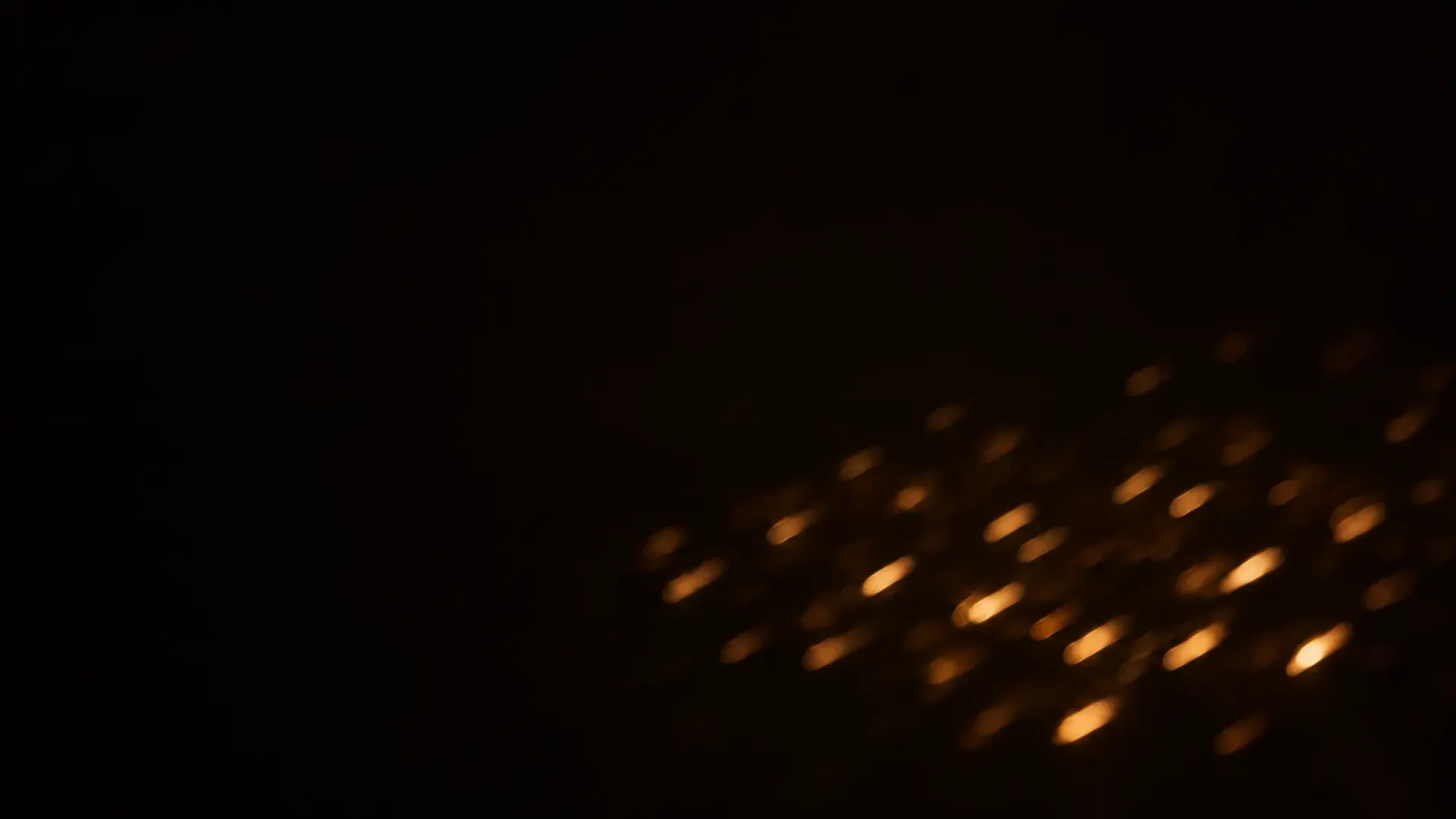Distant lights blurred into short streaks that all run in the same direction.