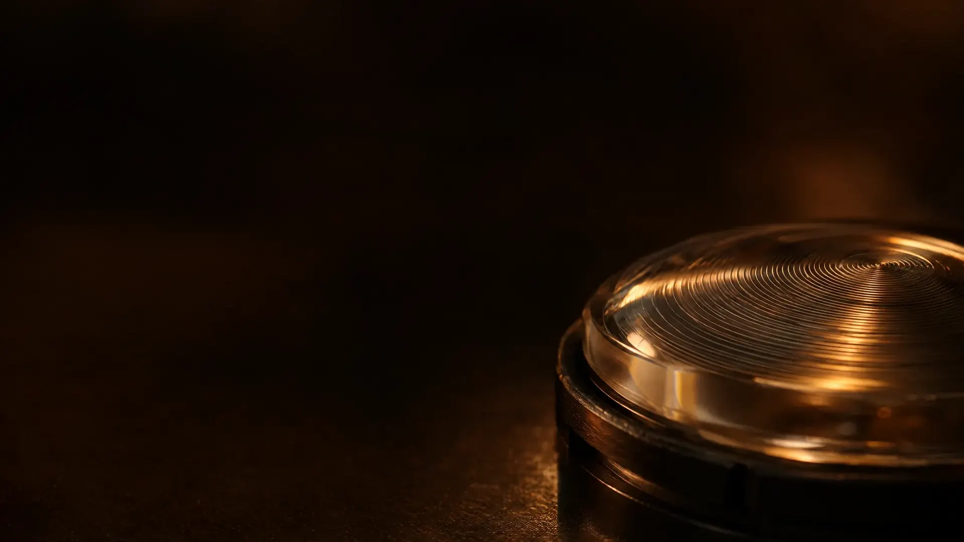A macro of a freshly surfaced lens, a fine spiral toolpath catching the light.