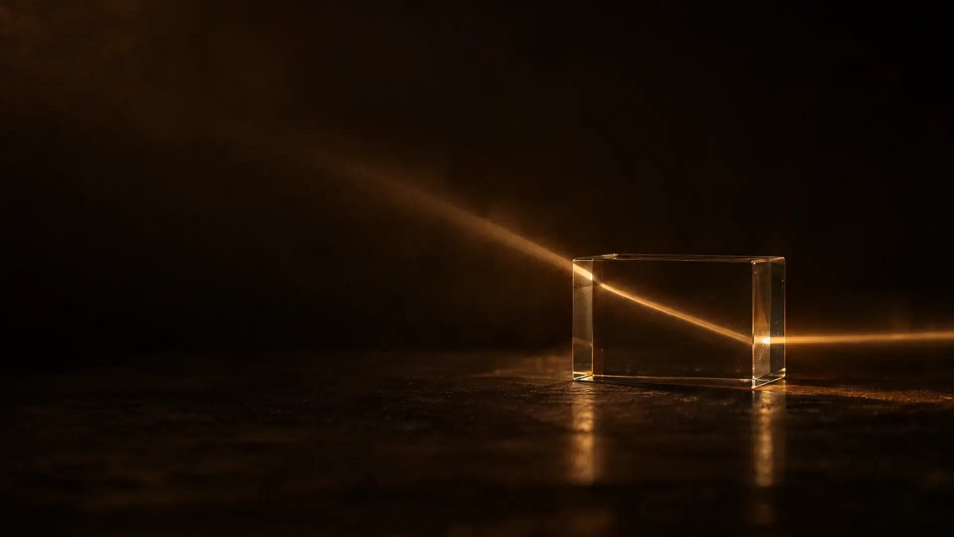 A beam of warm light bending as it enters a clear glass block, and again as it leaves.
